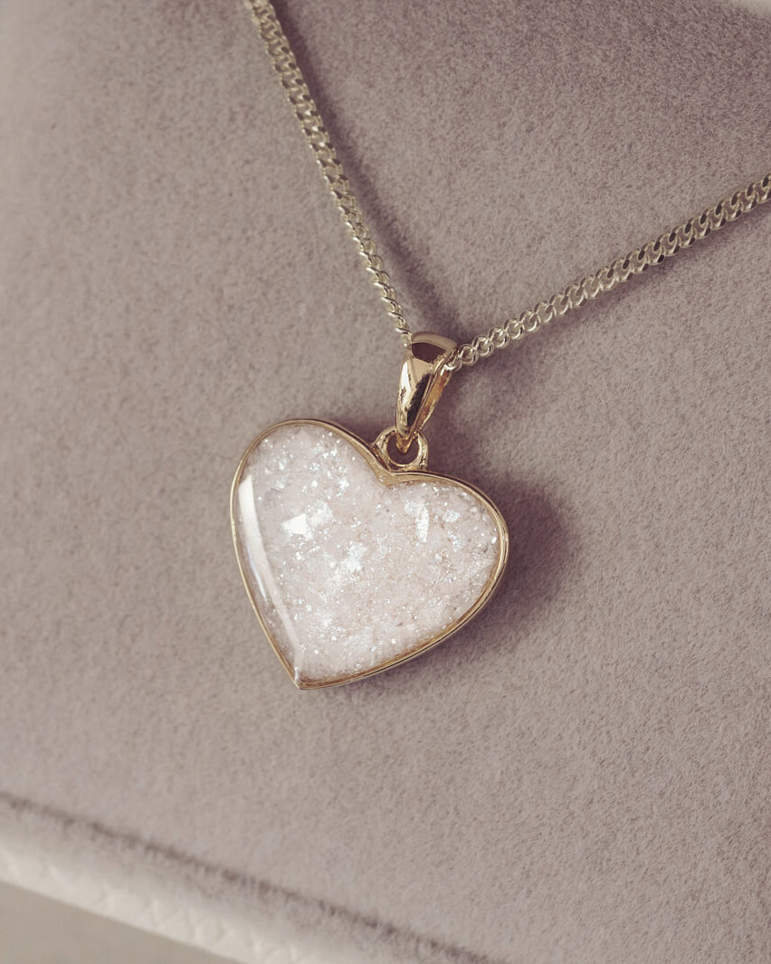 gold heart necklace filled with clear crystals, resin and cremation ashes