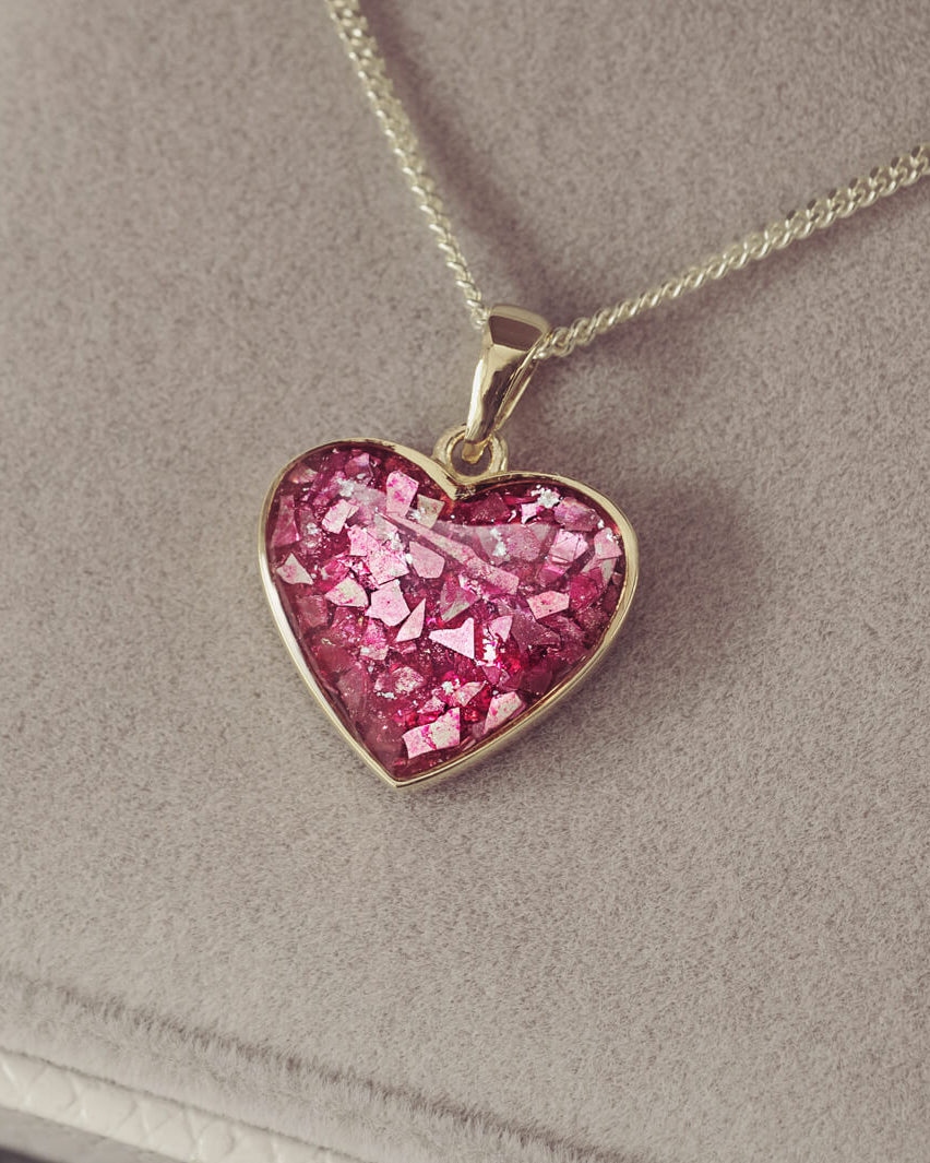 gold heart necklace filled with pink crystals, resin and cremation ashes