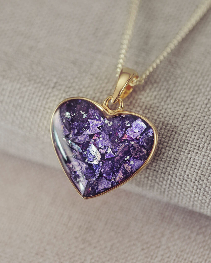 gold heart necklace filled with purple crystals, resin and cremation ashes