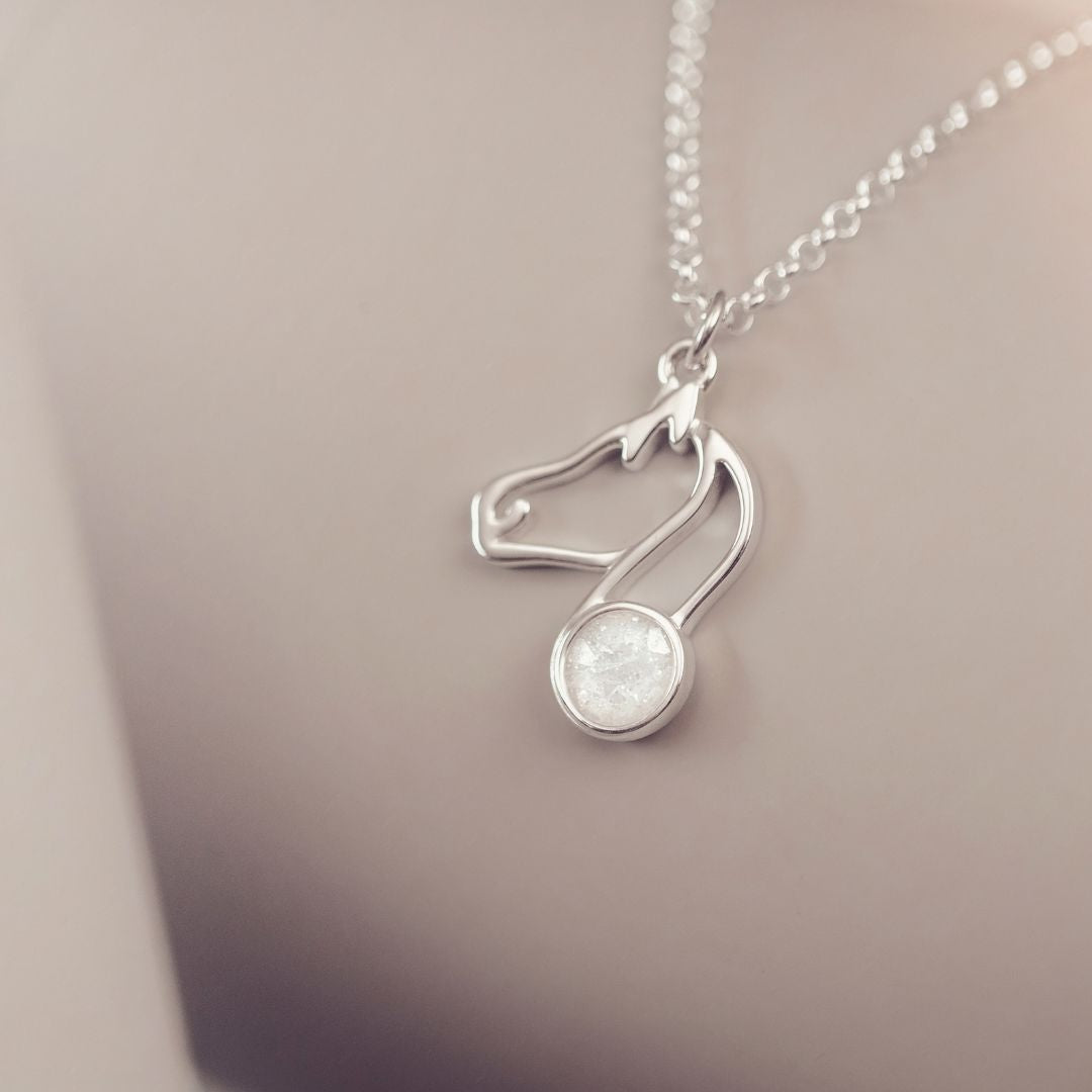 Silver necklace with a pendant on a neutral background