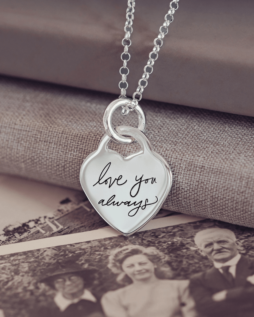 Lock Heart Handwriting Necklace featuring the handwritten message 'Love you always' displayed on a background of old photographs