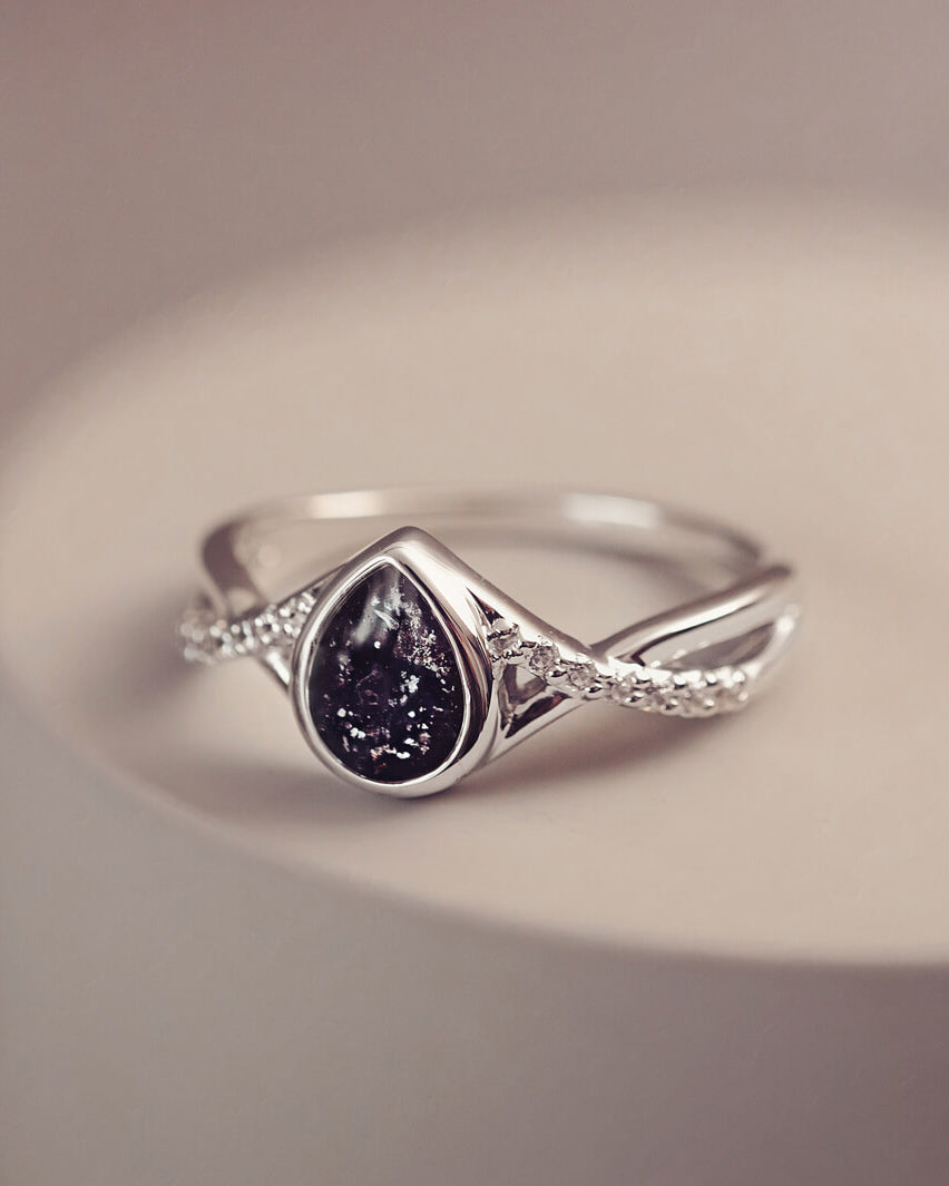 Sterling silver, peardrop shaped ring with a black stone, created using cremation ashes and crystal