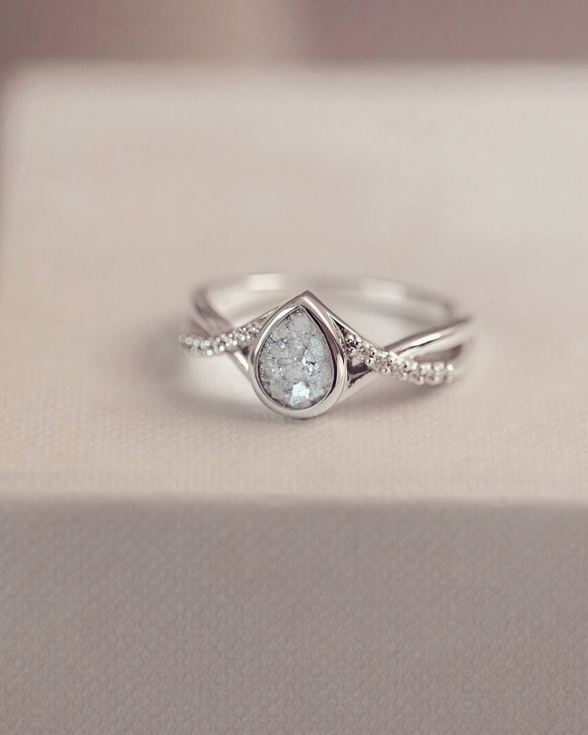 Sterling silver, peardrop shaped ring with a clear stone, created using cremation ashes and crystal