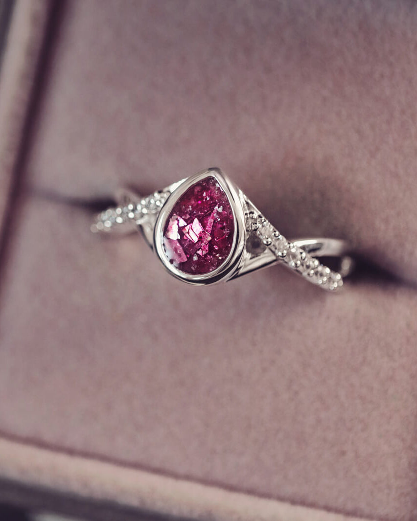 Sterling silver, peardrop shaped ring with a pink stone, created using cremation ashes and crystal