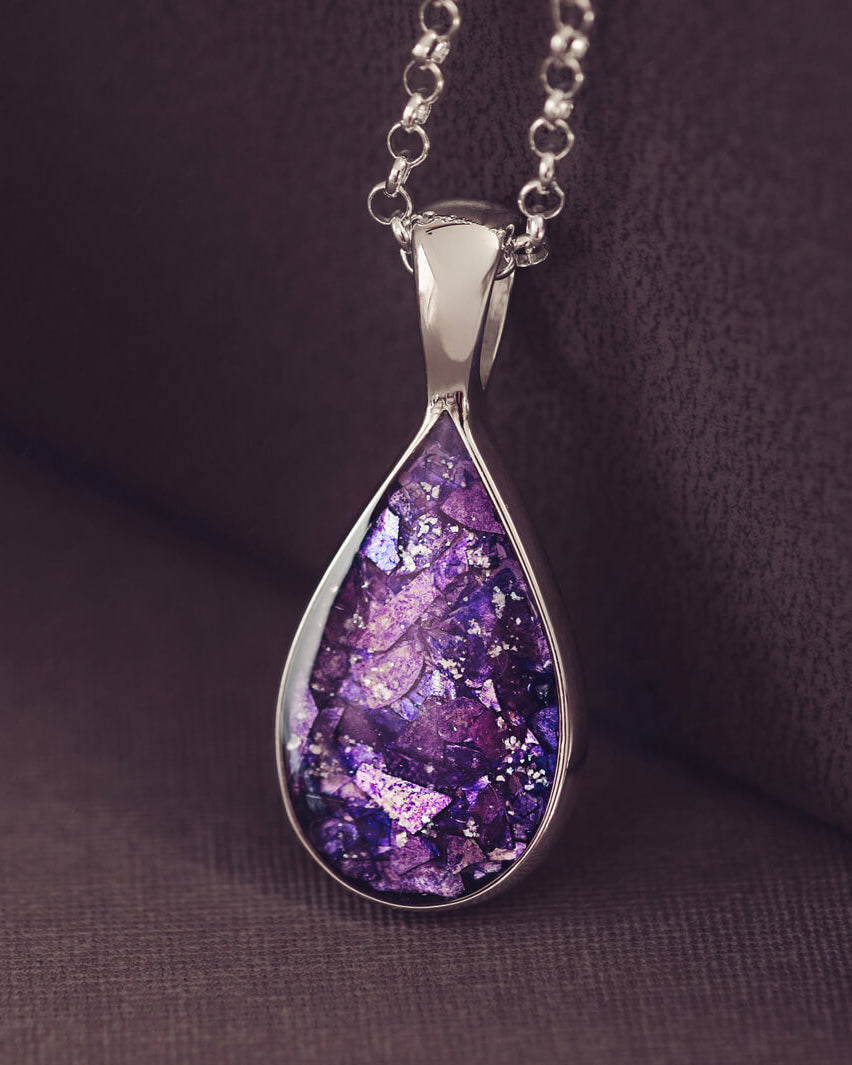 Teardrop shaped sterling silver pendant, filled with purple crystals and cremation ashes