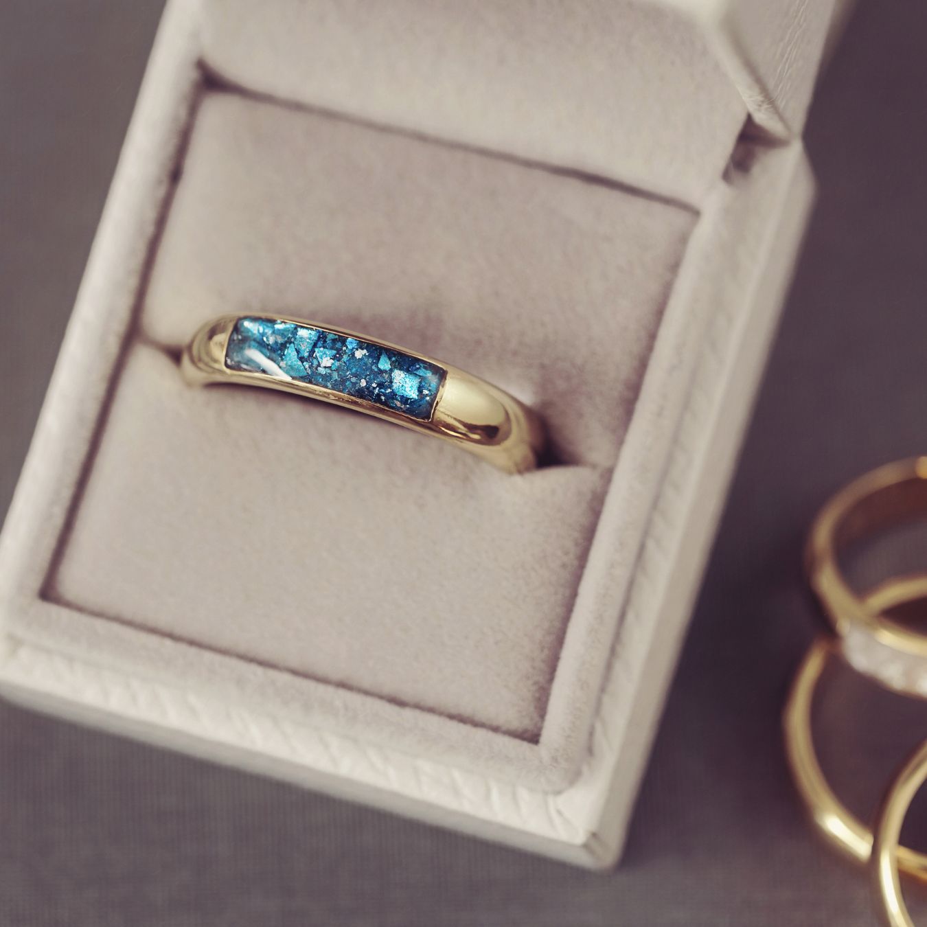 Gold ring with blue gemstones in a jewelry box