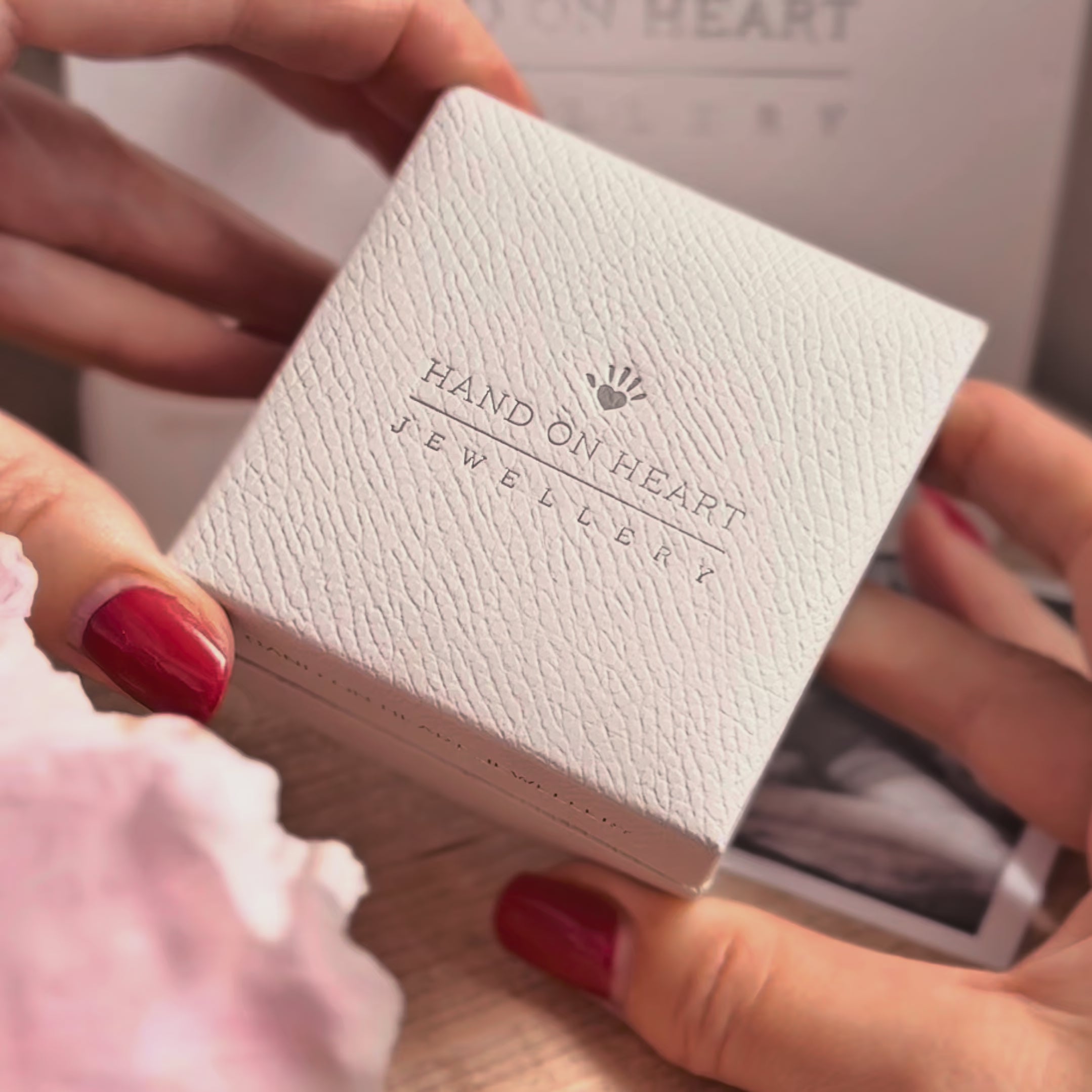 Video showing a blue ashes charm in the shape of an angel in a jewellery box