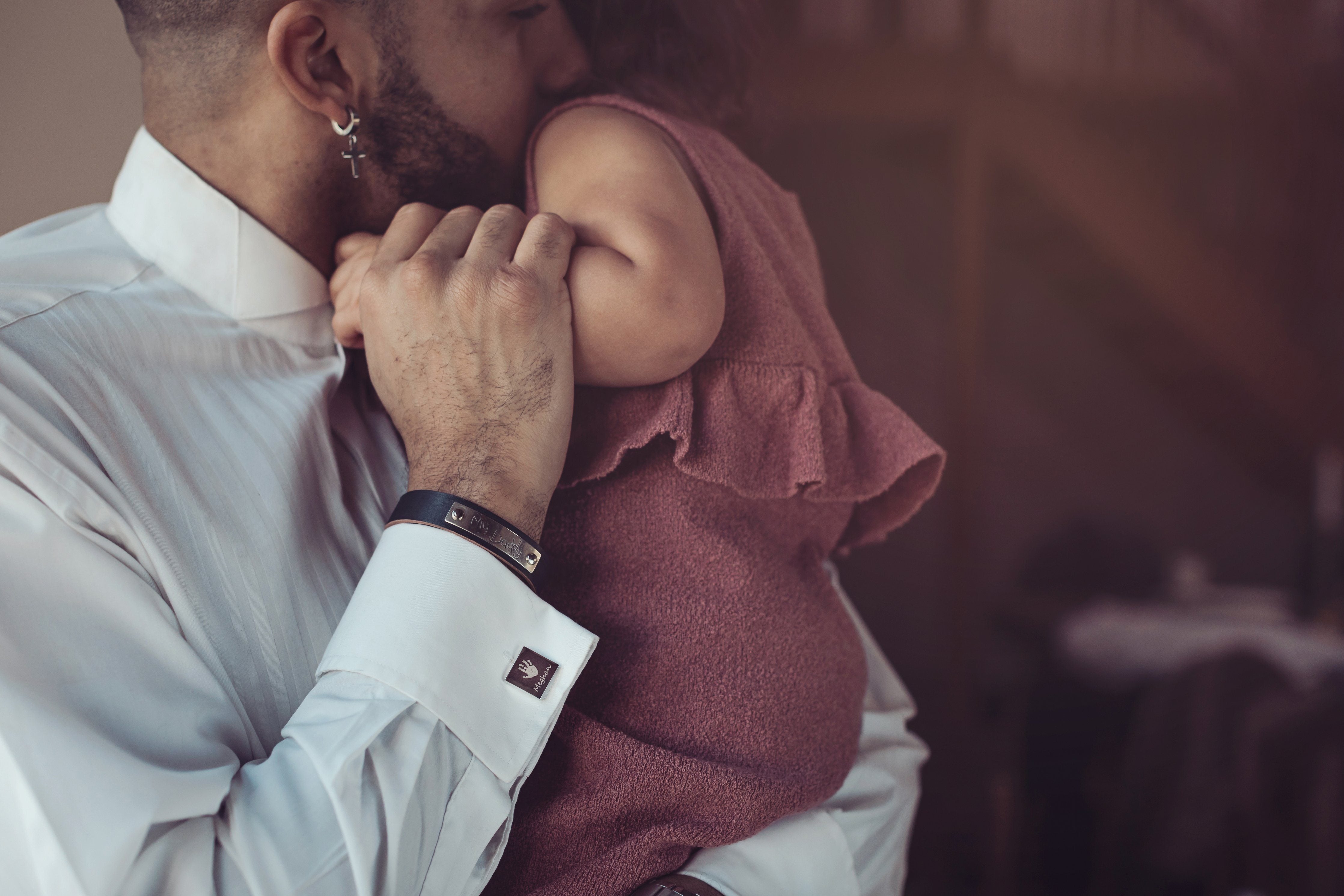 A father holding his daughter in his arms