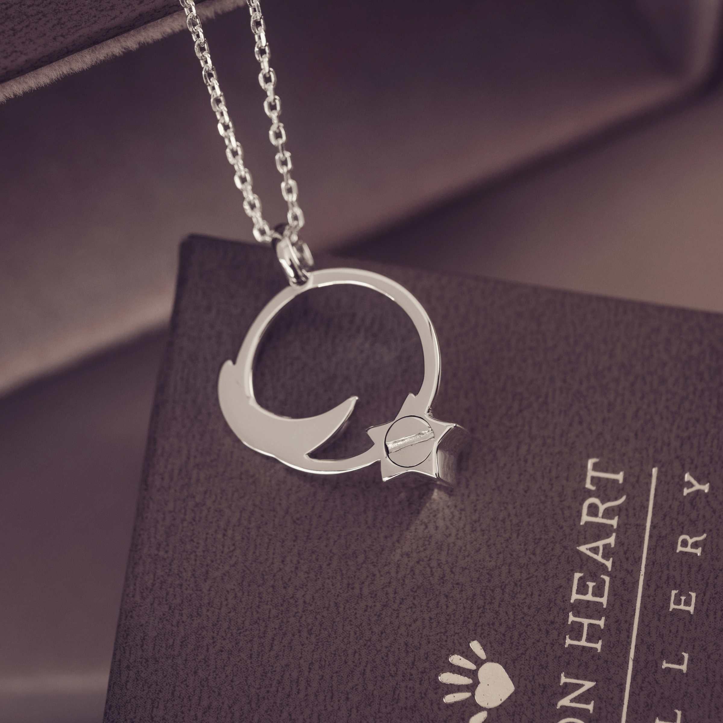 Silver necklace with a pendant on a dark surface