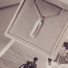 Silver necklace with a rectangular pendant in a jewellery box