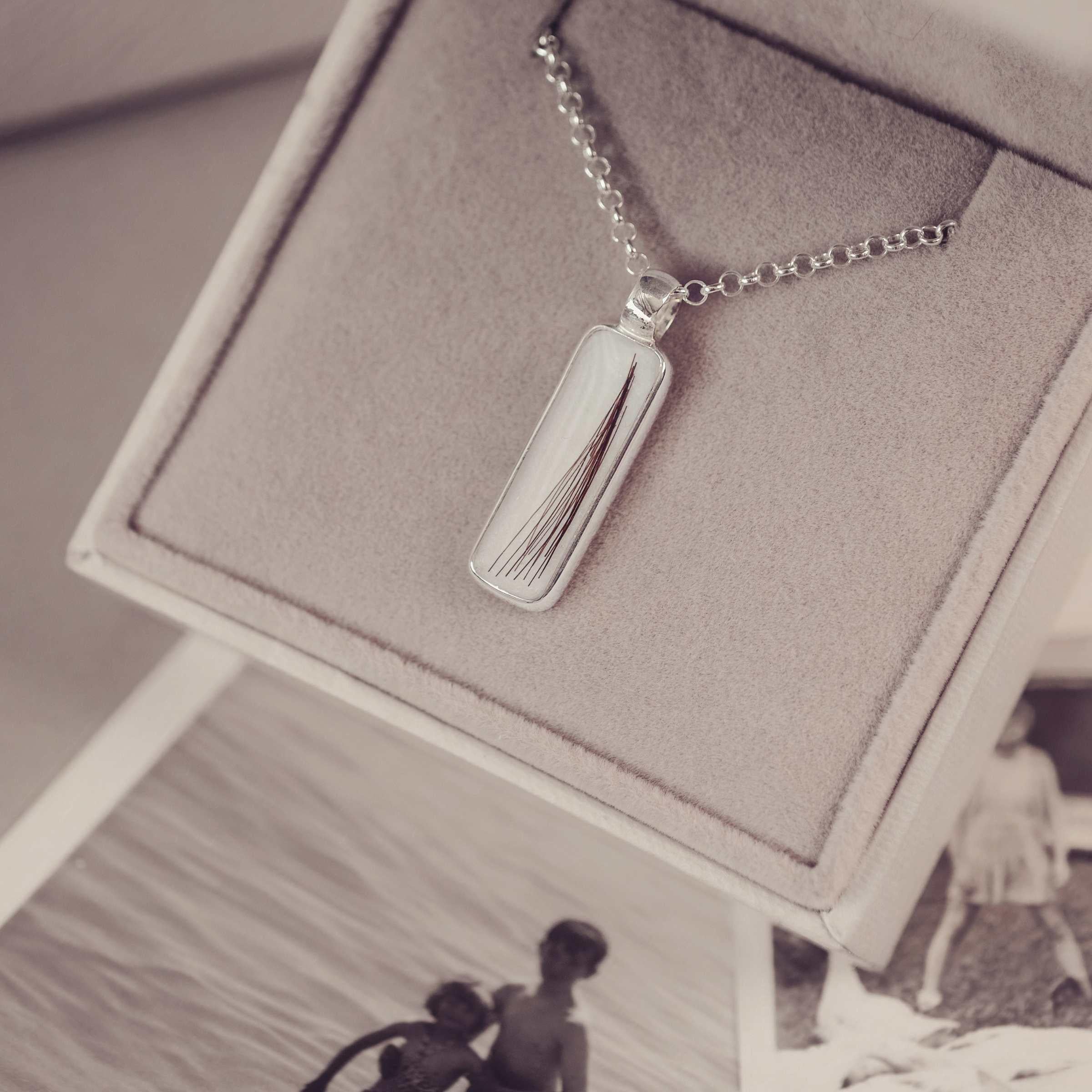 Silver necklace with a rectangular pendant in a jewellery box