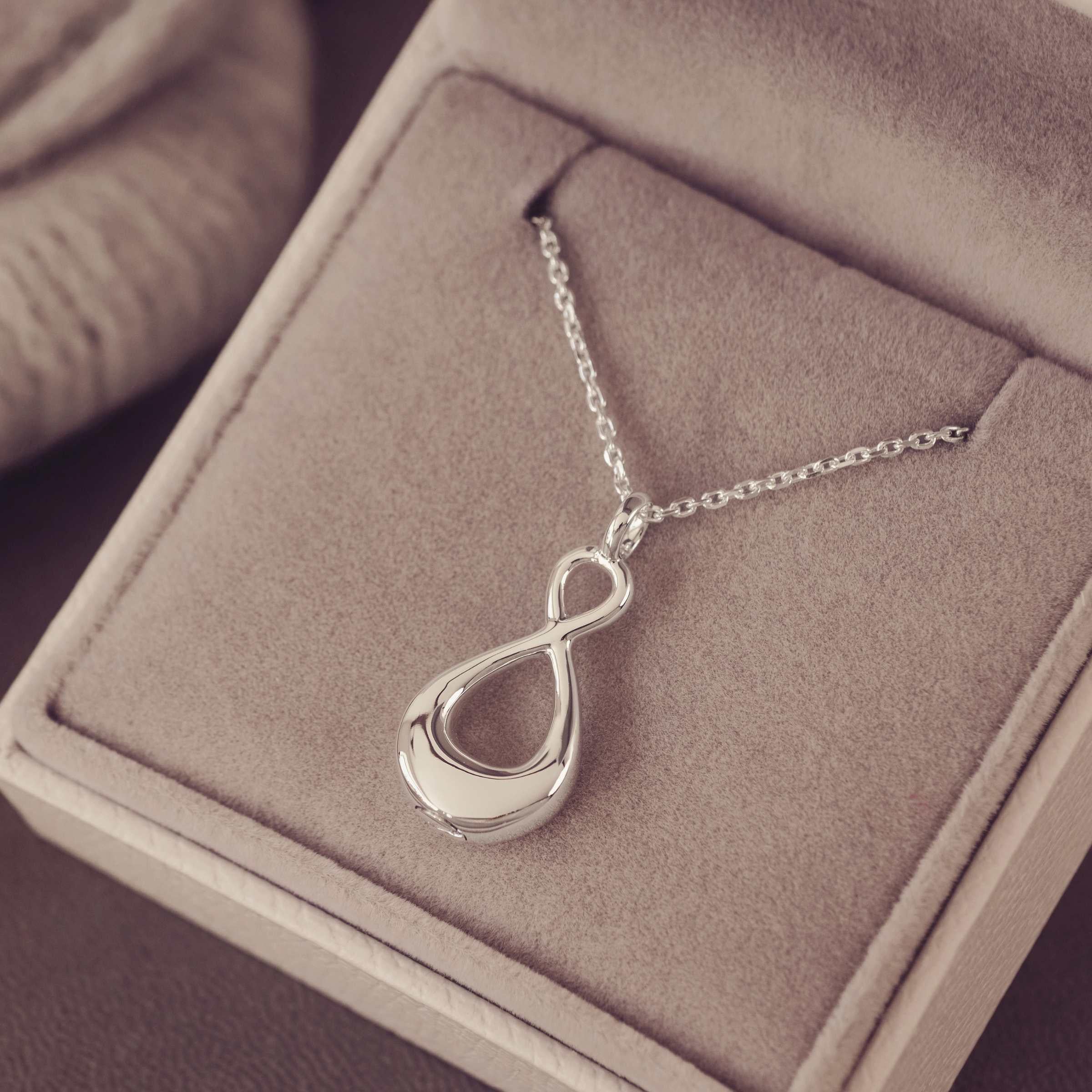 Silver necklace with an infinity pendant in a jewellery box
