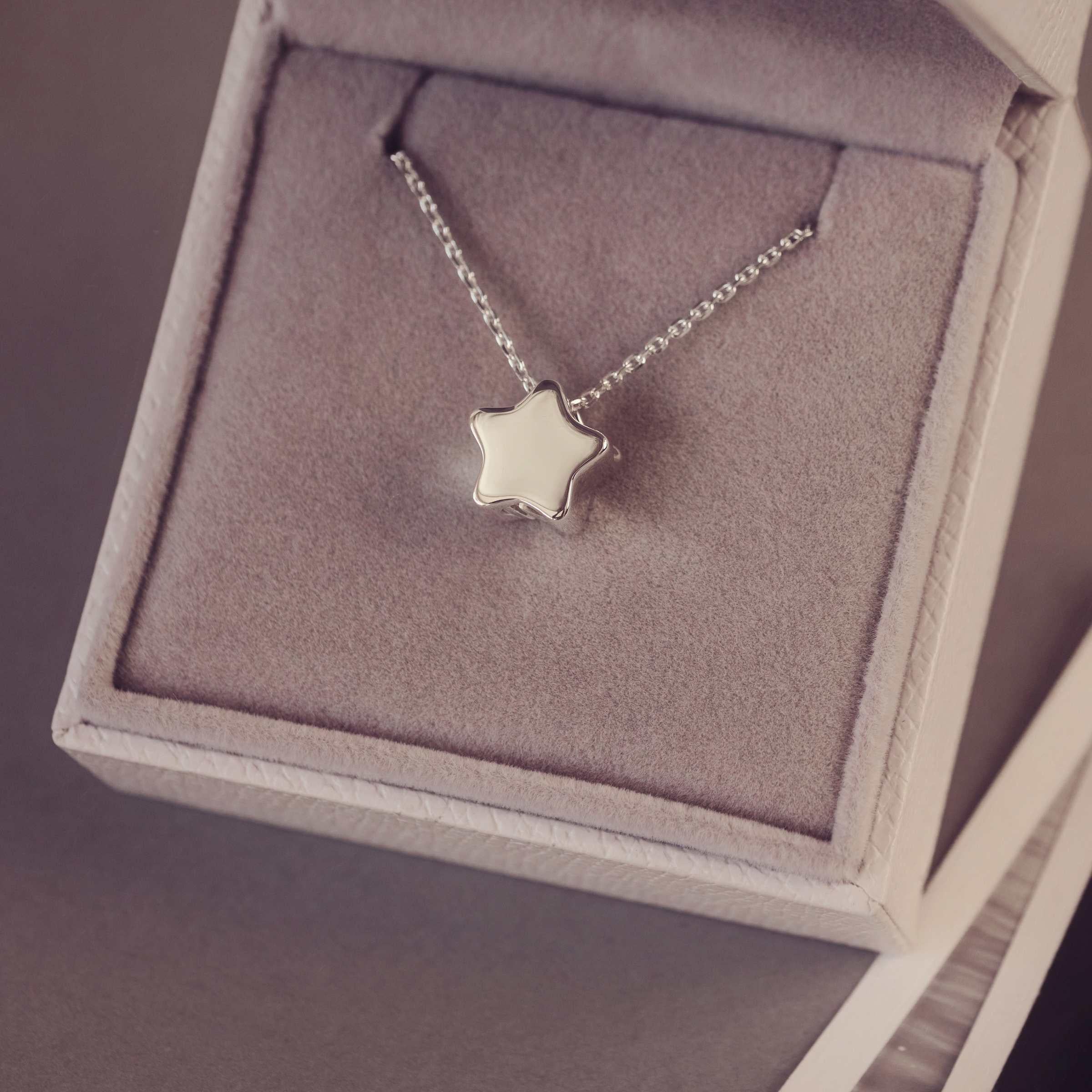 Silver star necklace in a jewellery box