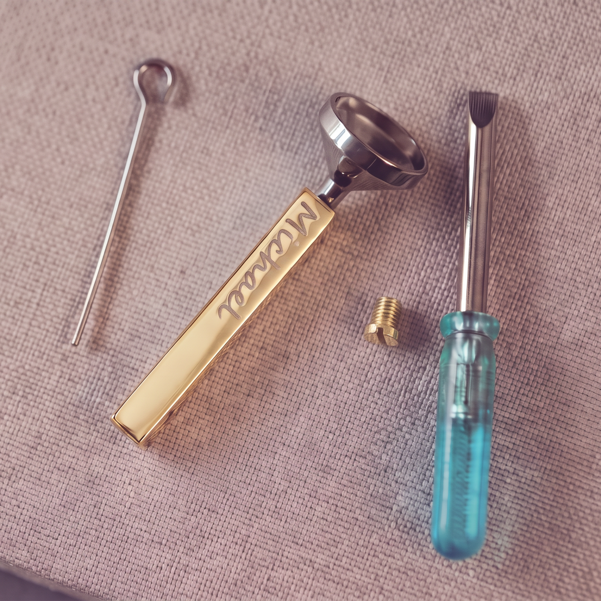 A gold bar pendant with a set of tools