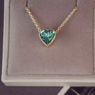 Heart-shaped green pendant necklace in a jewellery box