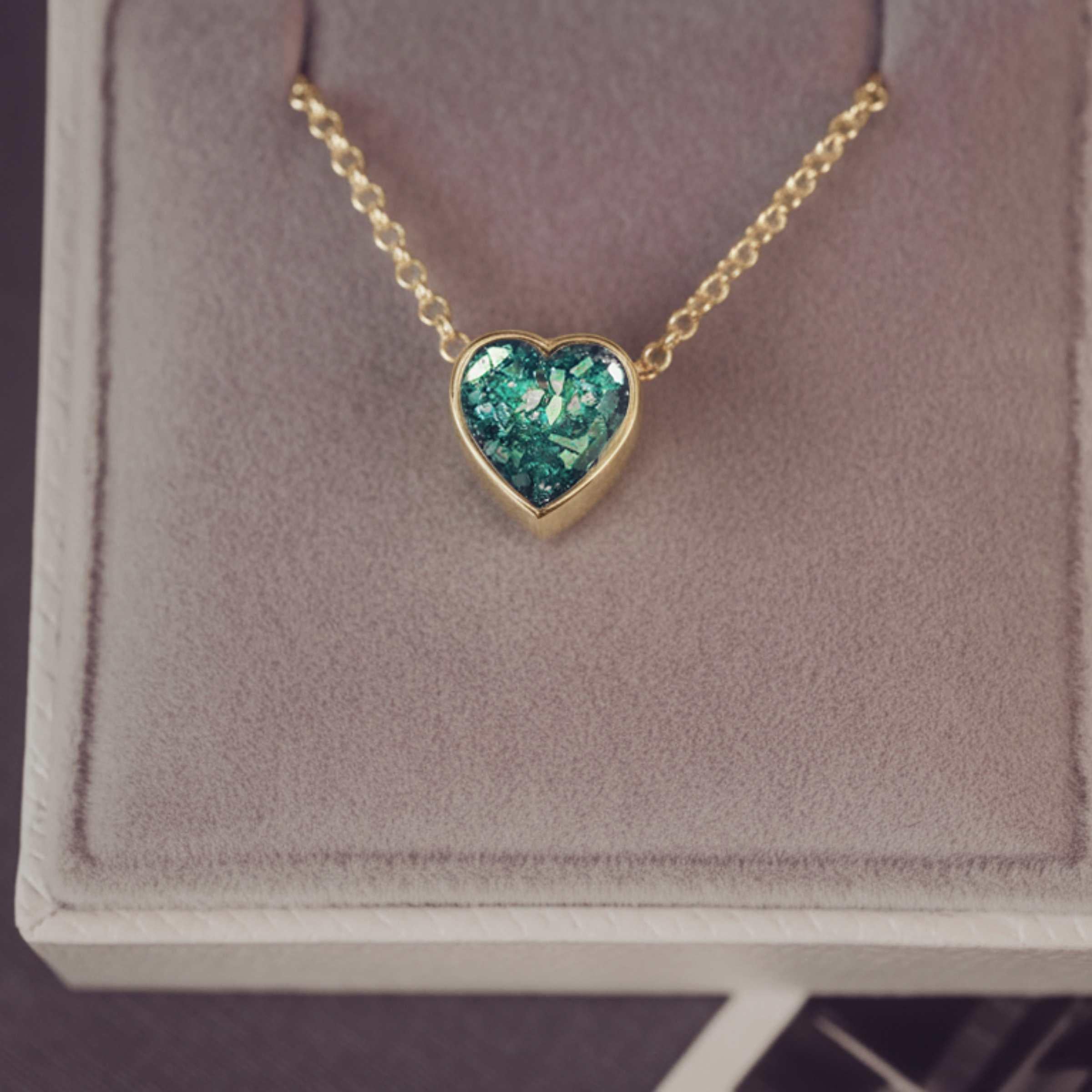 Heart-shaped green pendant necklace in a jewellery box