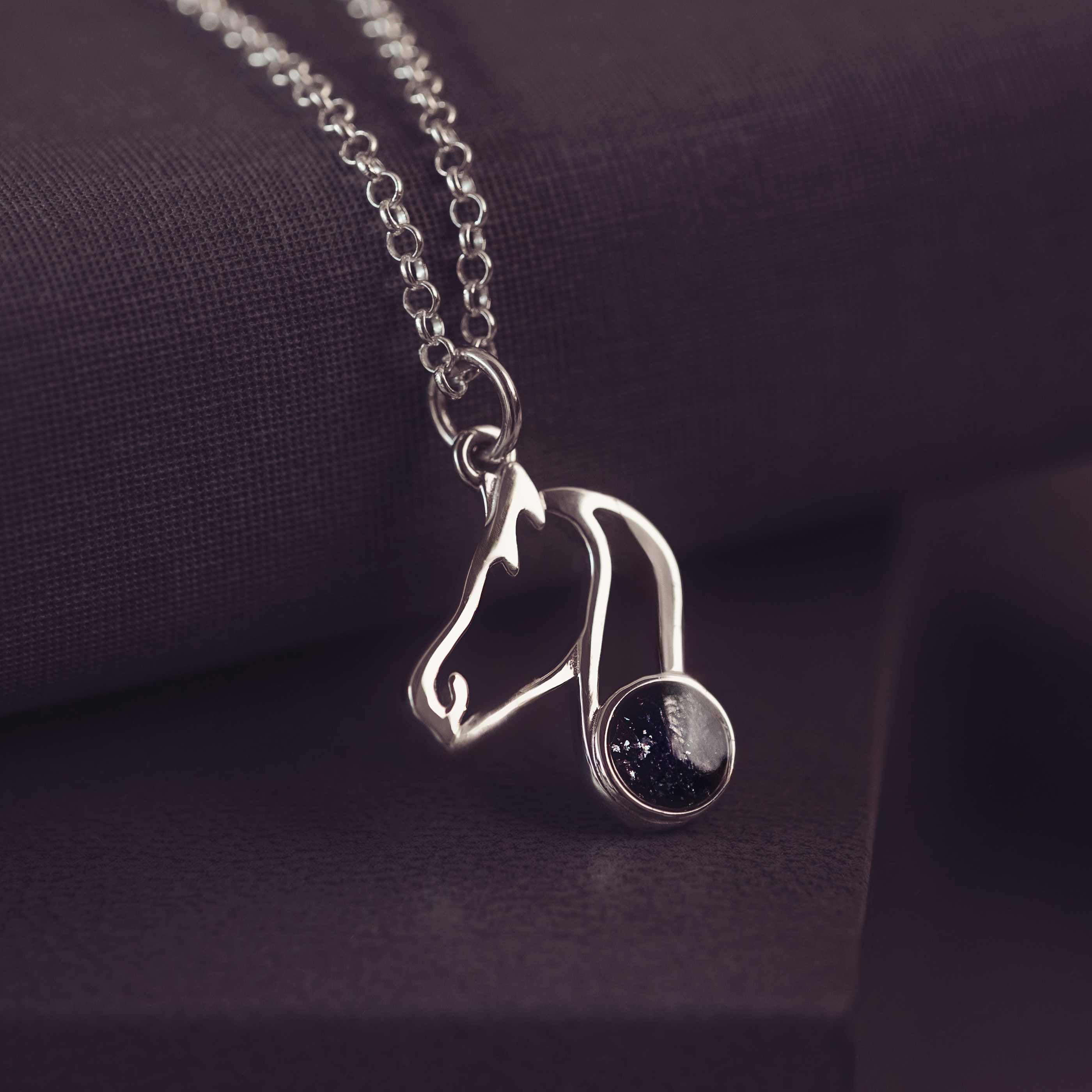 Silver Horse Shaped pendant on a silver chain with black gemstones