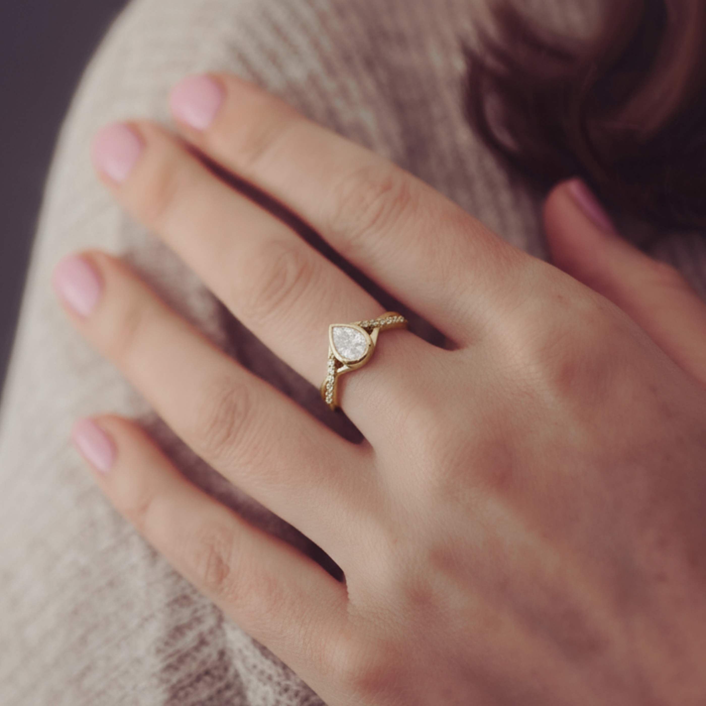 Gold ring with a diamond on a person's finger
