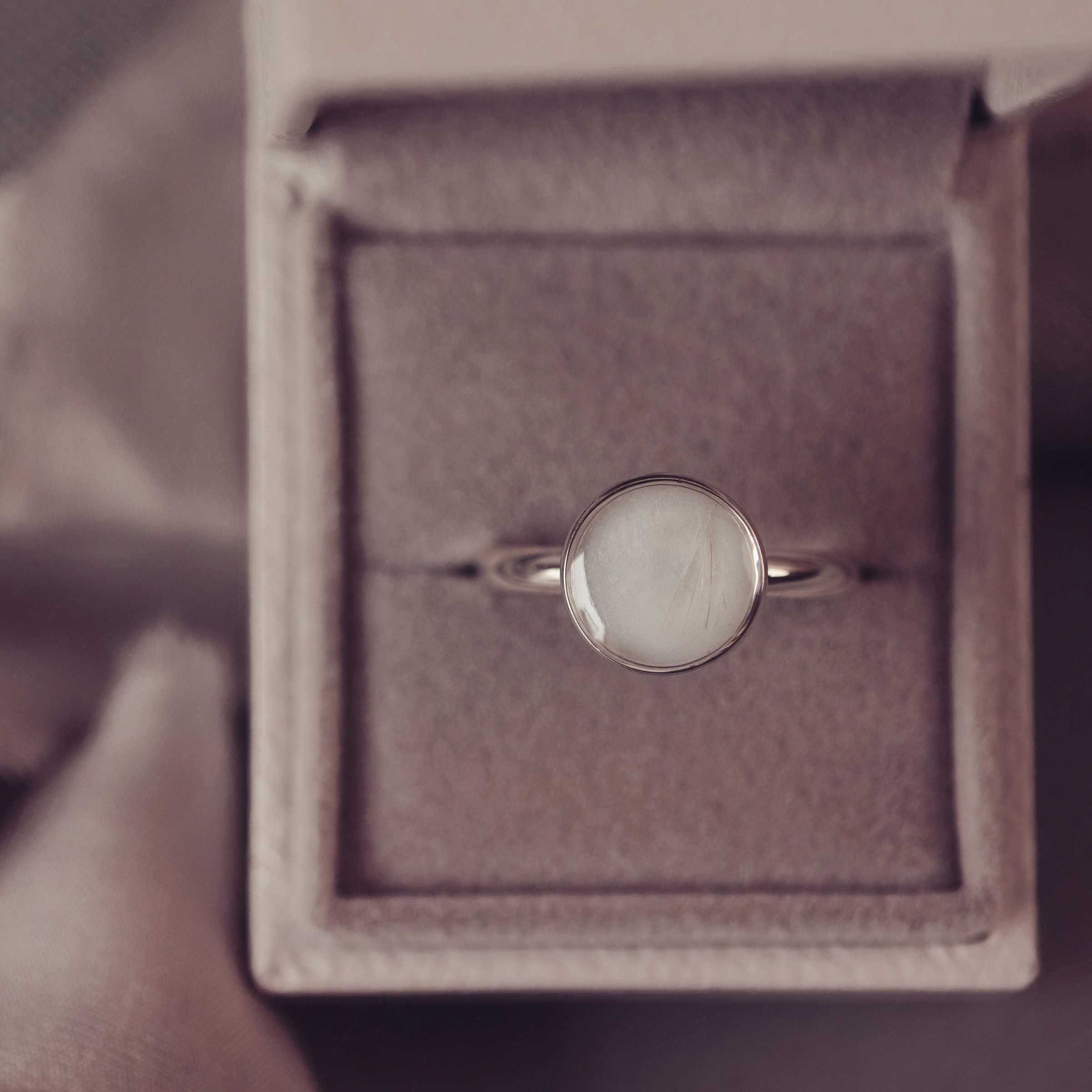 Silver ring with a round shape in a jewellery box