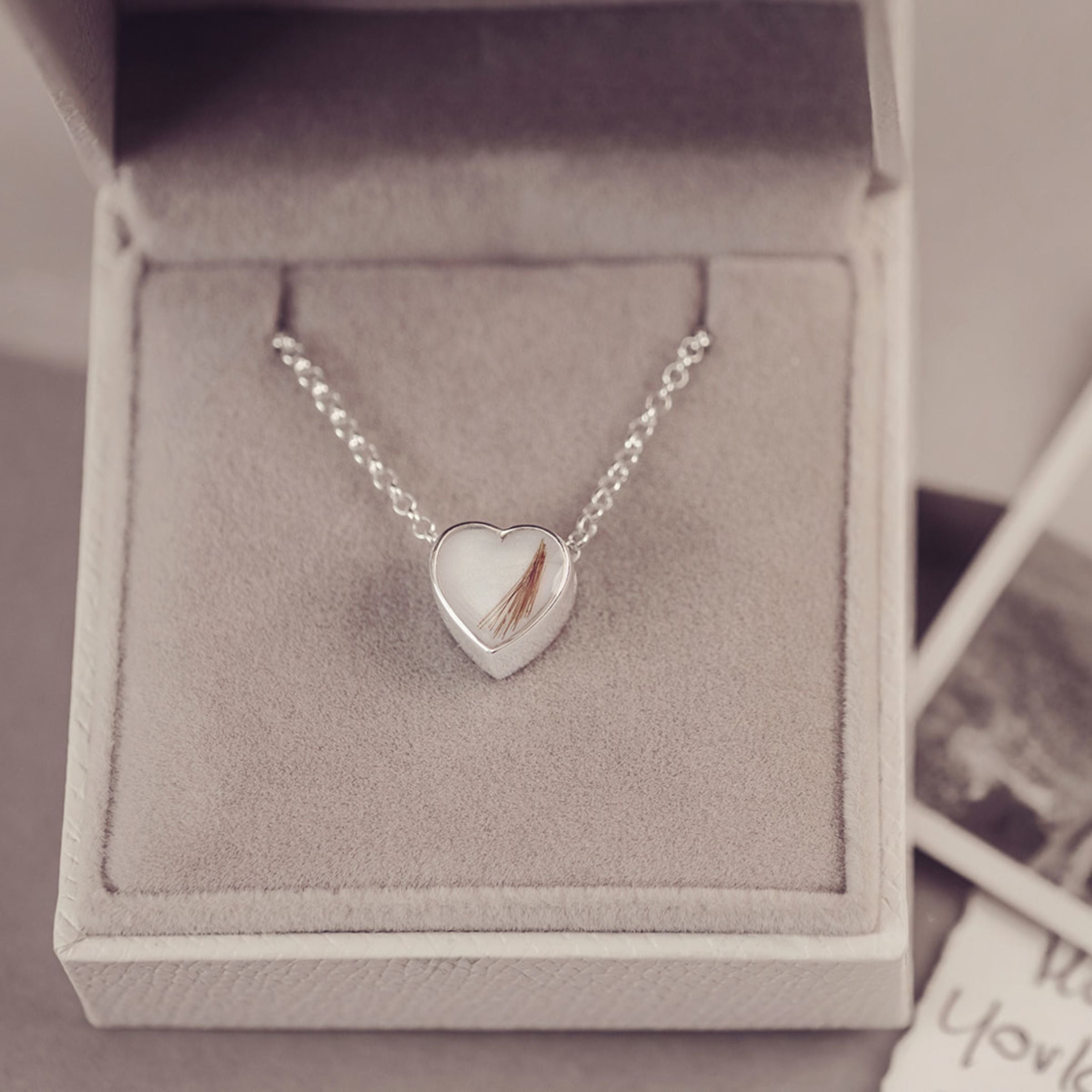 Silver heart-shaped pendant necklace in a jewelry box