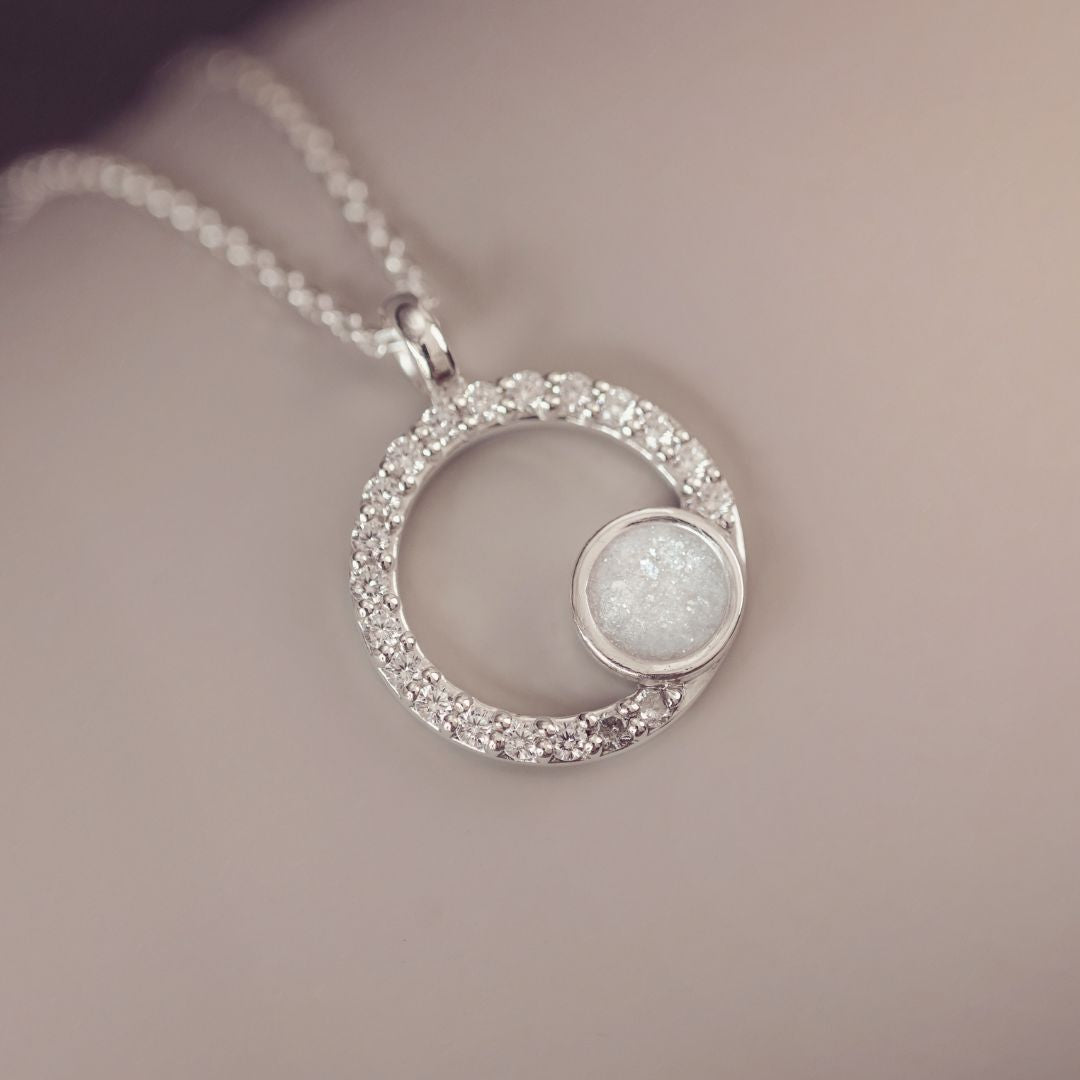 Silver necklace with a circular pendant on a soft background