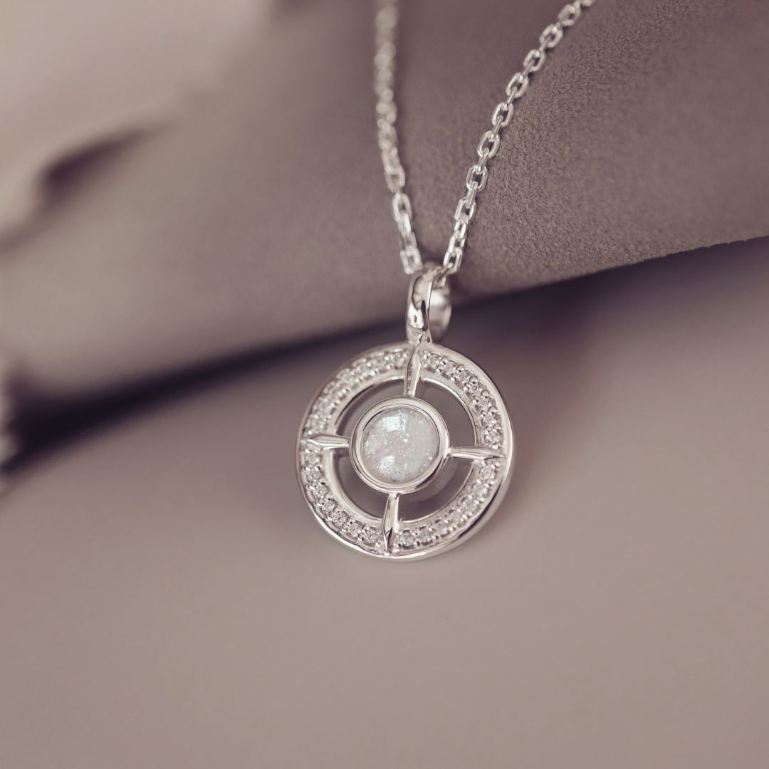 Silver necklace with a circular pendant on a soft background