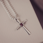 silver cross necklace holding cremation ashes, resin and brown crystal