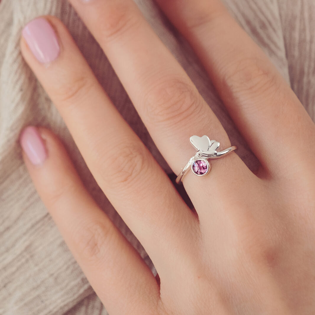 Sterling Silver Butterfly Ring, holding cremation ashes and pink crystal, on a ladies hand