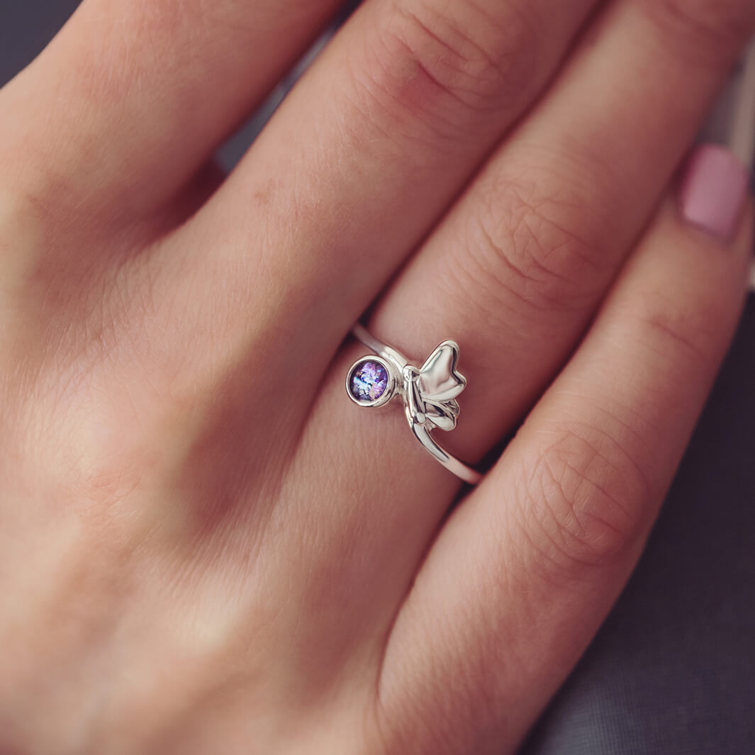 Sterling Silver Butterfly Ring, holding cremation ashes and purple crystal, on a ladies hand