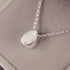 Peardrop shaped silver pendant, filled with white crystal & cremation ashes, on a silver chain