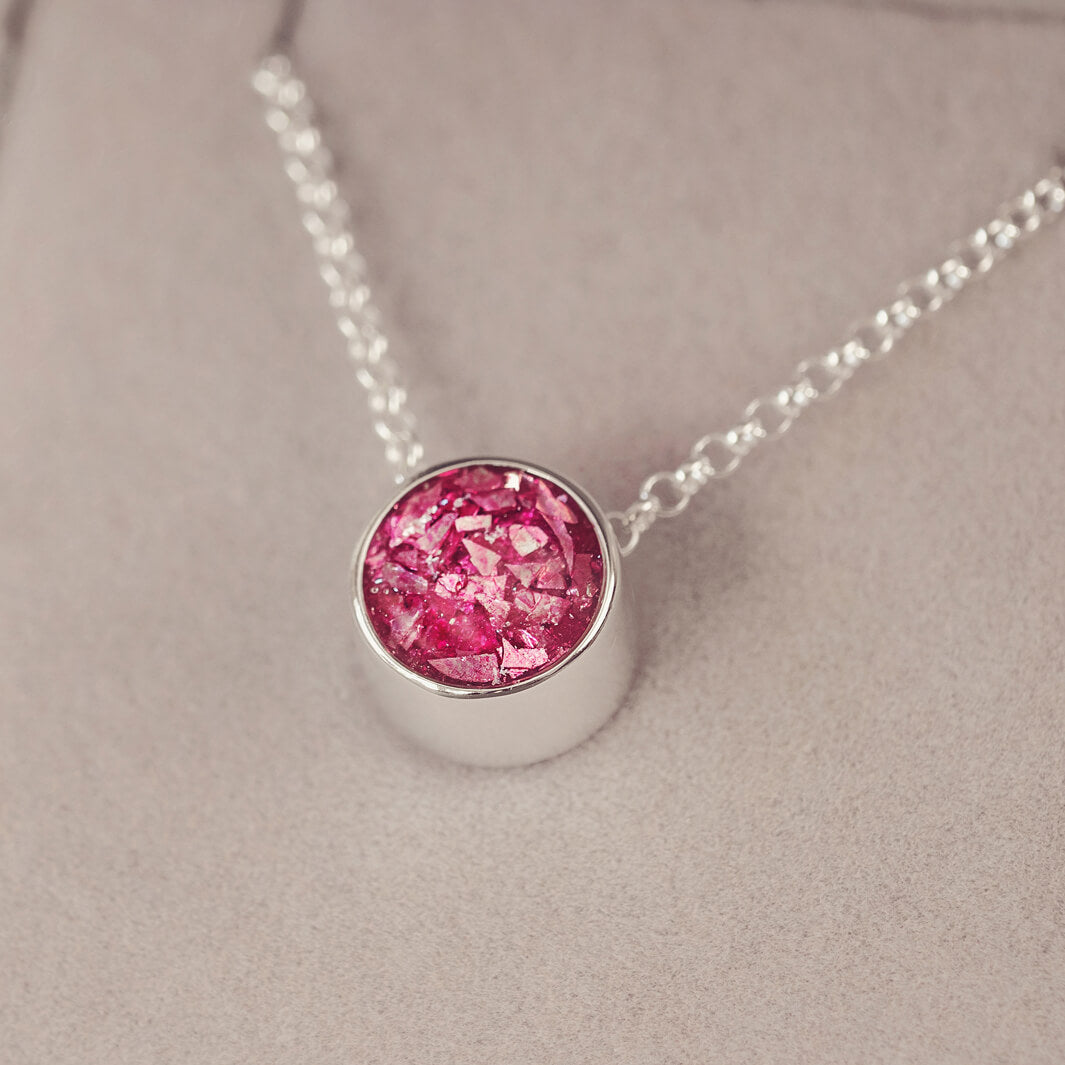 Round silver charm on silver chain, filled with pink crystal, glitter, resin & ashes. 