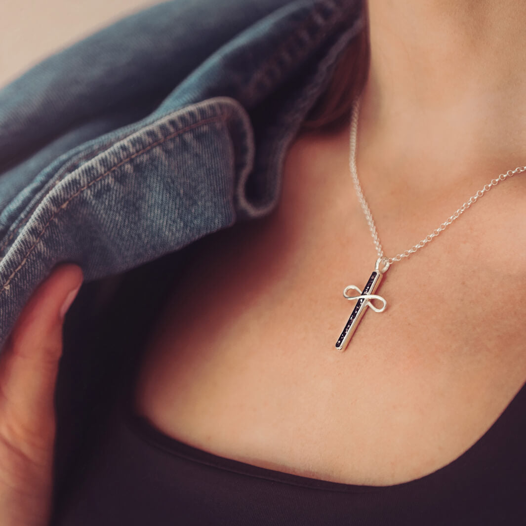 Cremation Ashes Infinity Cross Necklace, worn on a silver chain around a ladies neck