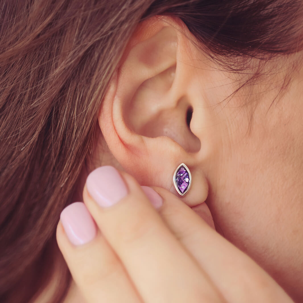 Marquise Style Earrings, worn on a models ear, filled with purple crystal and cremation ashes