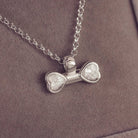 sterling silver bone shaped necklace, filled with cremation ashes, clear crystal and resin.
