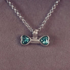 sterling silver bone shaped necklace, filled with cremation ashes, green crystal and resin.