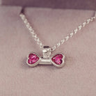 sterling silver bone shaped necklace, filled with cremation ashes, pink crystal and resin.