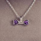 sterling silver bone shaped necklace, filled with cremation ashes, purple crystal and resin.