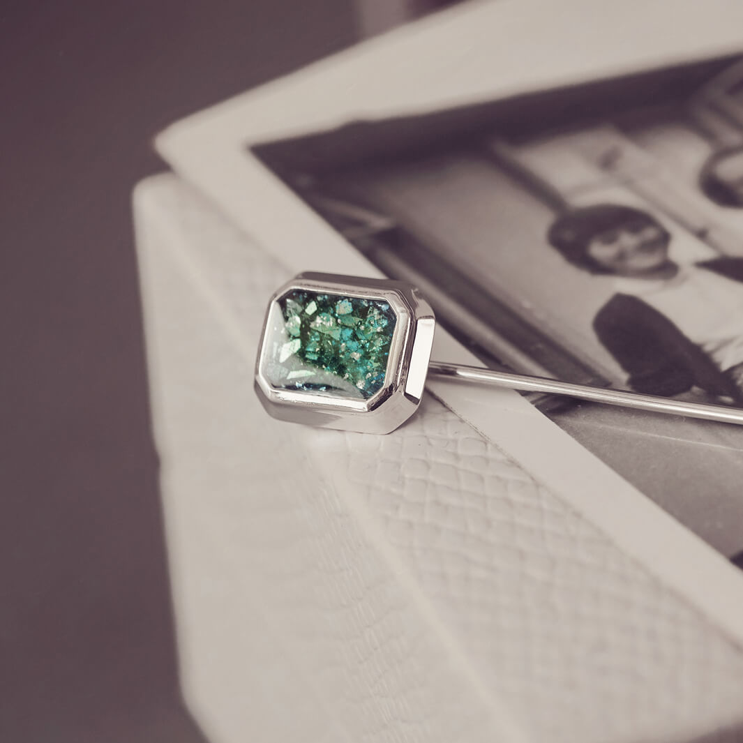 silver tie pin, created with green crystals, resin and cremation ashes. 