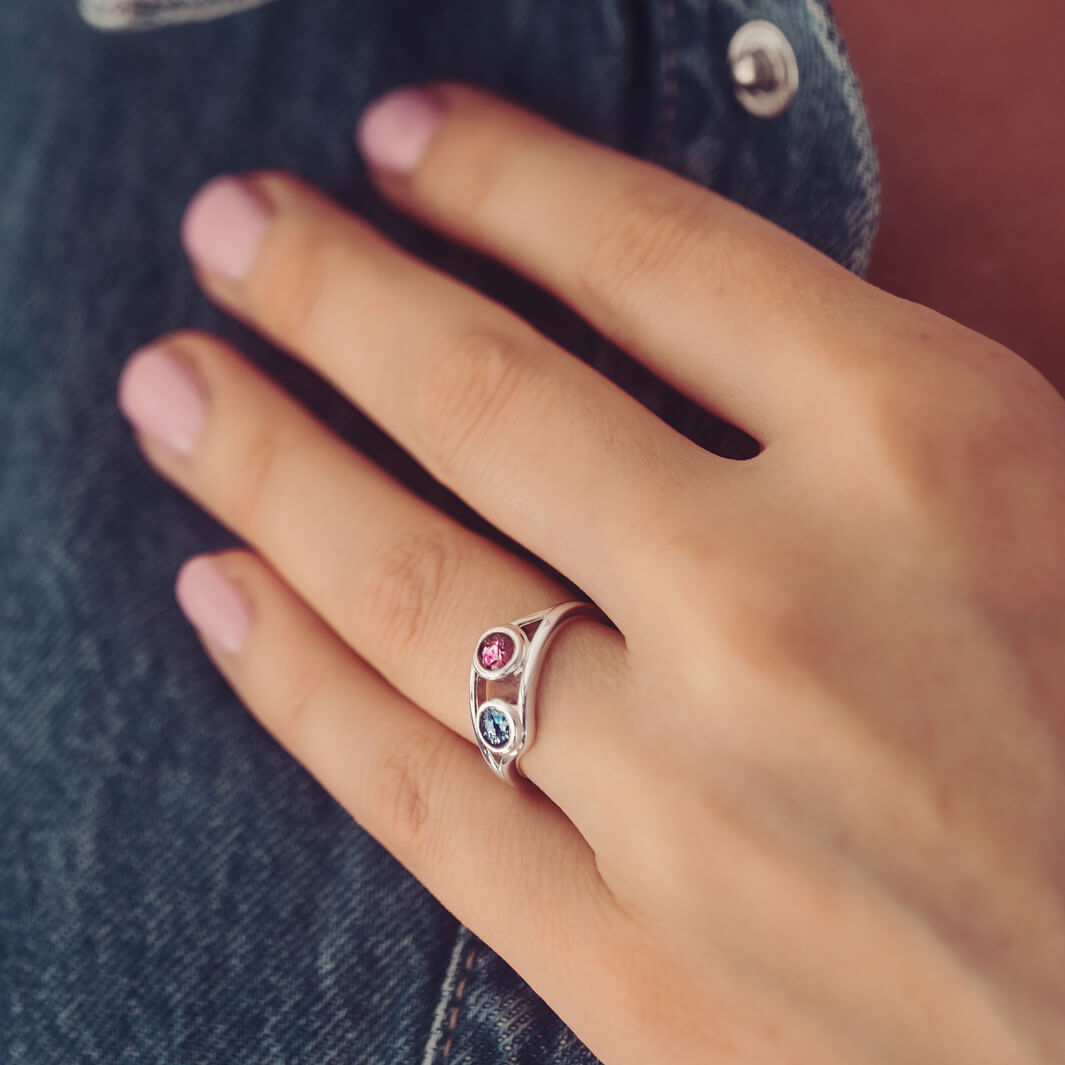 sterling silver ring with two circles created with coloured crystal and cremation ashes. 