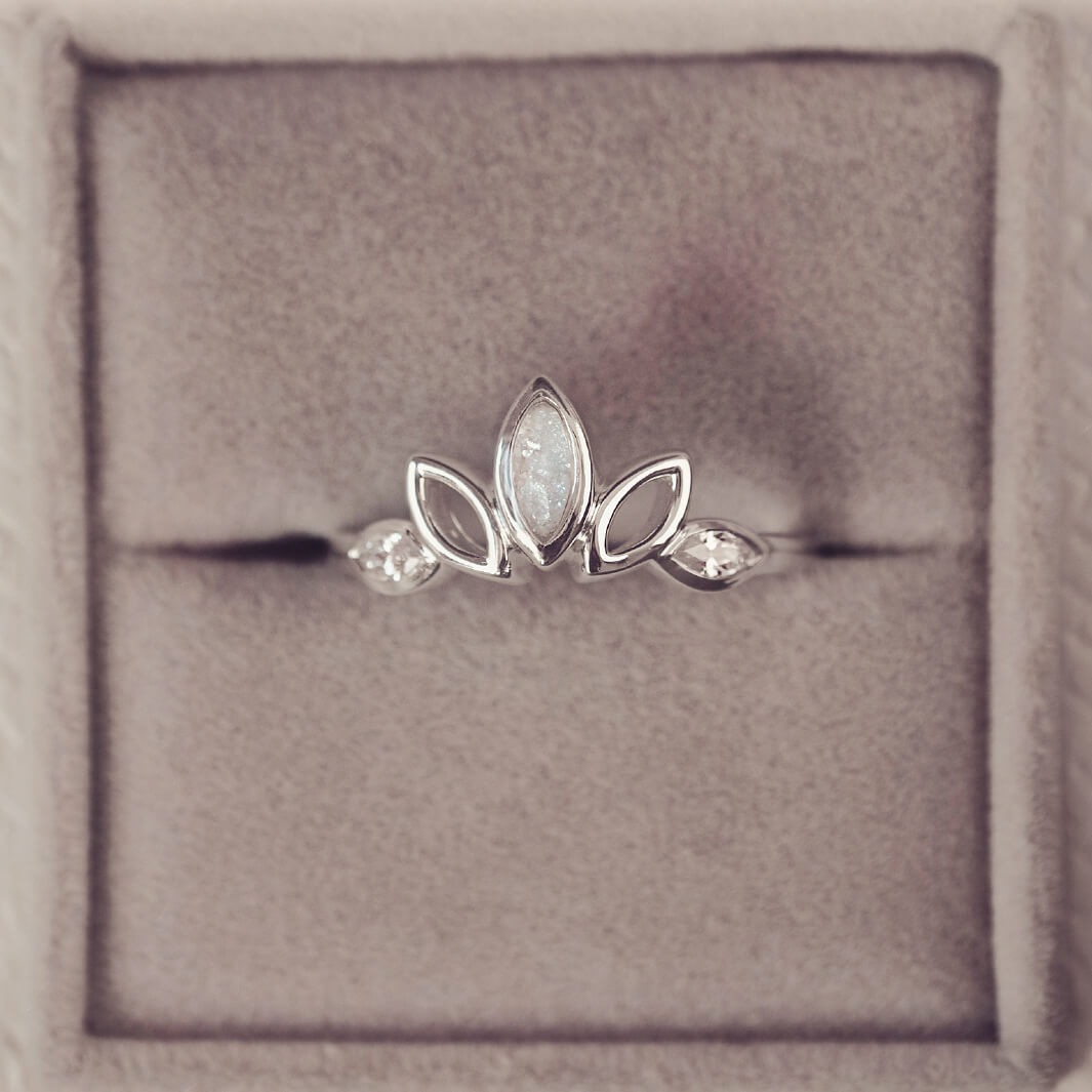 Sterling Silver Ring, created with your loved ones ashes, with Cubic Zircona gemstones. With clear floating crystals with in the ring in a grey jewellery box 