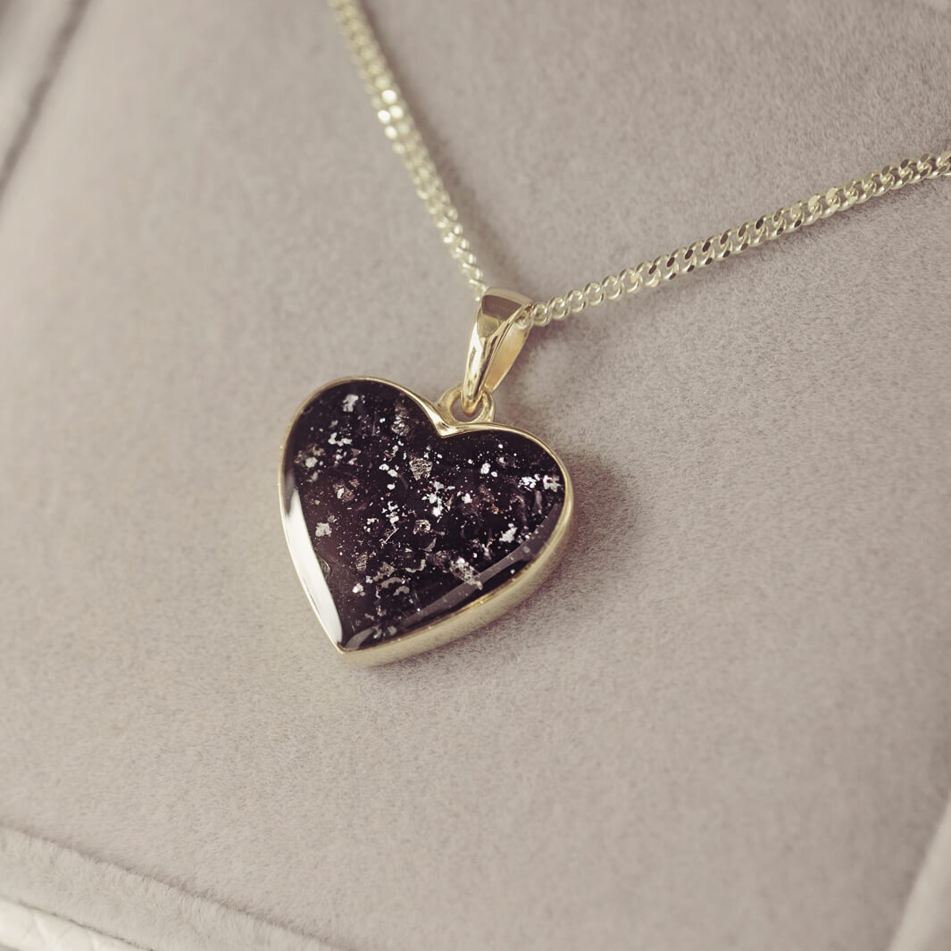 gold heart necklace filled with black crystals, resin and cremation ashes