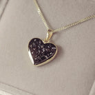 gold heart necklace filled with black crystals, resin and cremation ashes