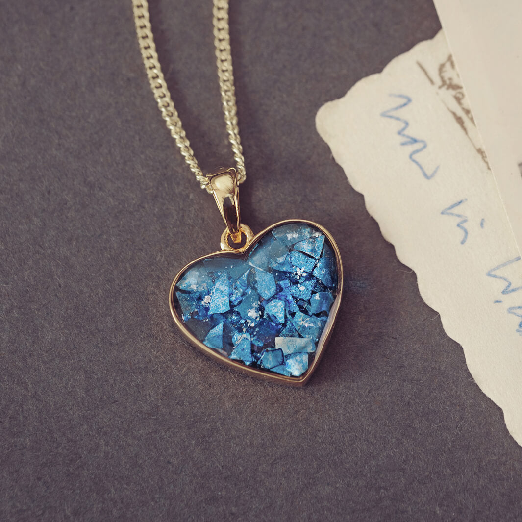 gold heart necklace filled with blue crystals, resin and cremation ashes