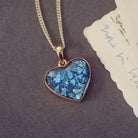 gold heart necklace filled with blue crystals, resin and cremation ashes