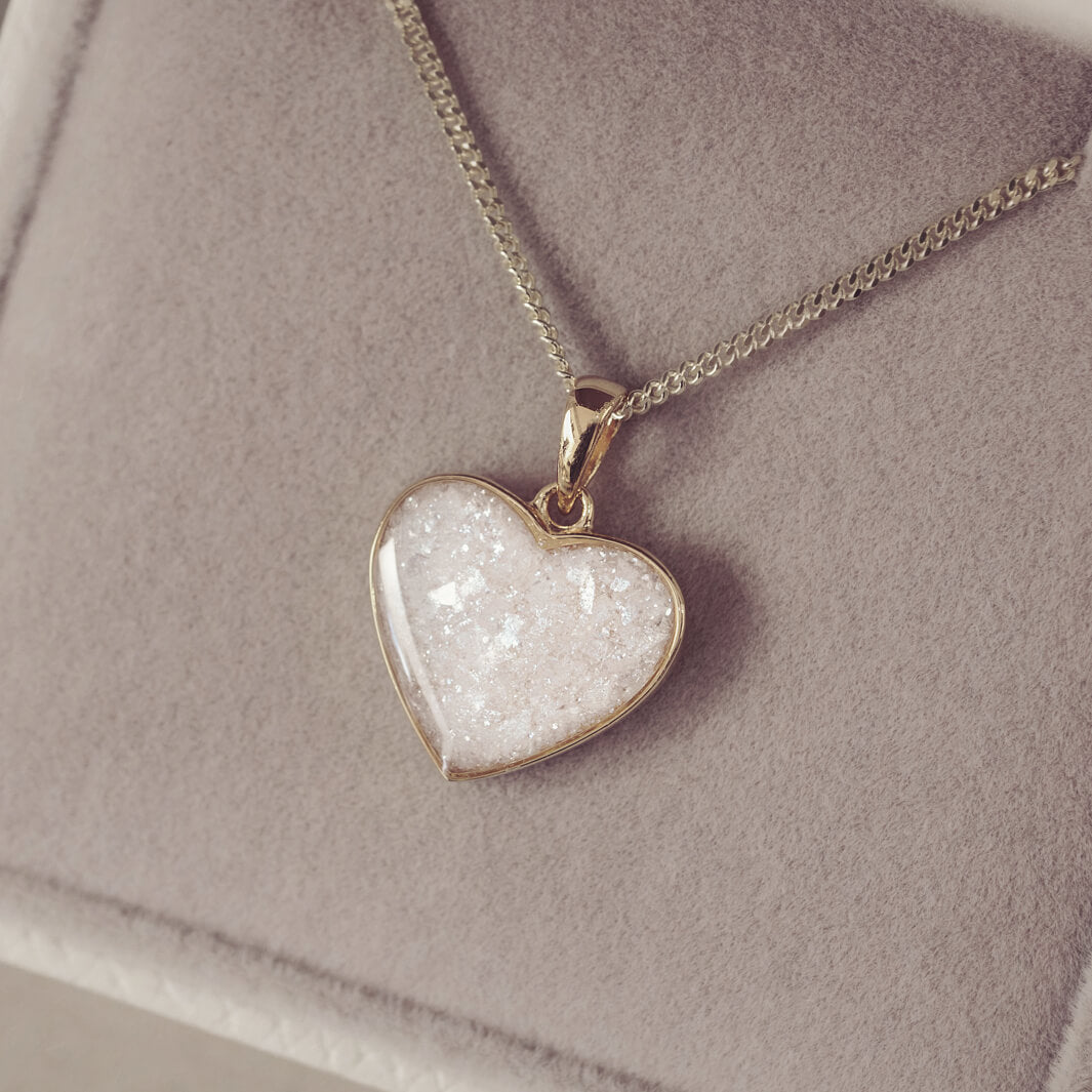 gold heart necklace filled with clear crystals, resin and cremation ashes