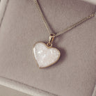 gold heart necklace filled with clear crystals, resin and cremation ashes
