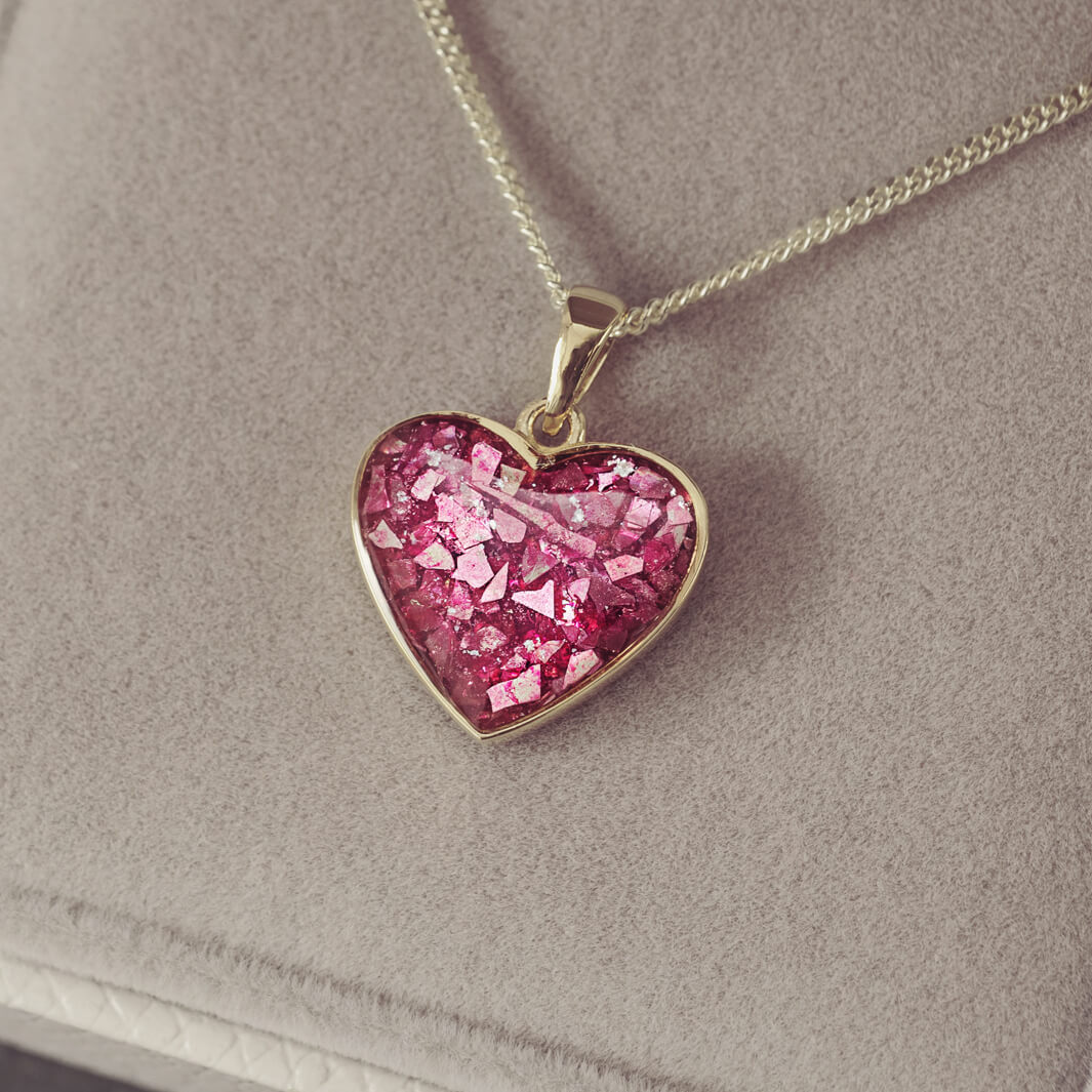 gold heart necklace filled with pink crystals, resin and cremation ashes
