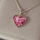 gold heart necklace filled with pink crystals, resin and cremation ashes