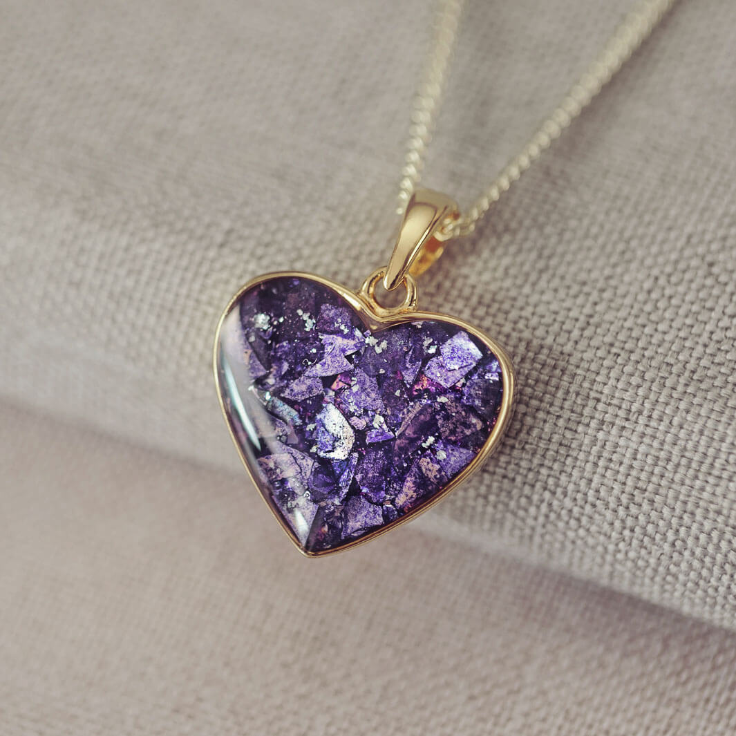 gold heart necklace filled with purple crystals, resin and cremation ashes