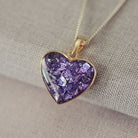 gold heart necklace filled with purple crystals, resin and cremation ashes